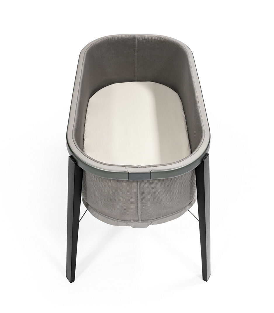 Stokke® Snoozi™ Graphite Grey with Fitted Sheet Vanilla Cream. Top view.