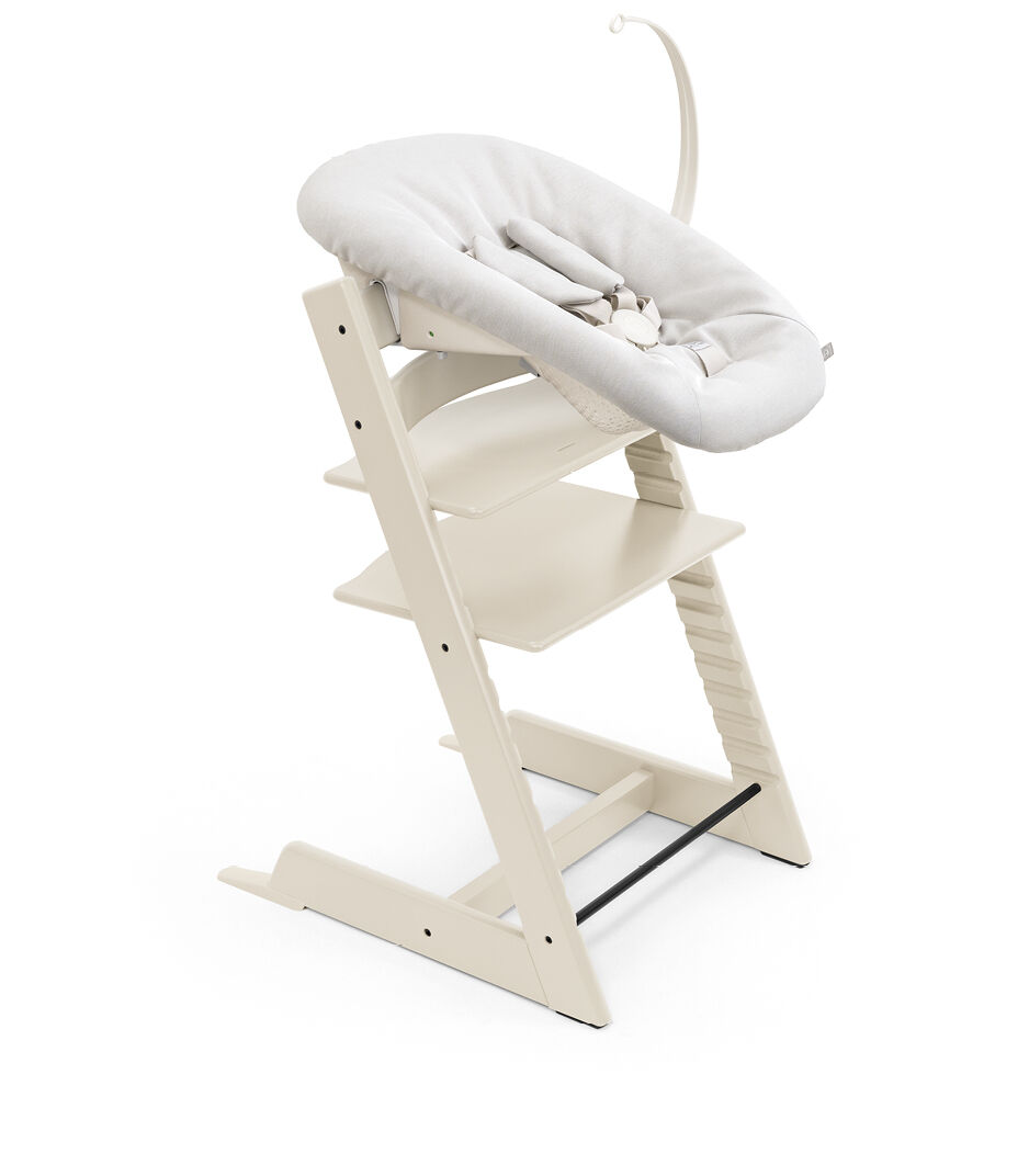 Tripp Trapp® chair Vanilla White, with Newborn Set Wanilla. Toy Hanger.  Active position.