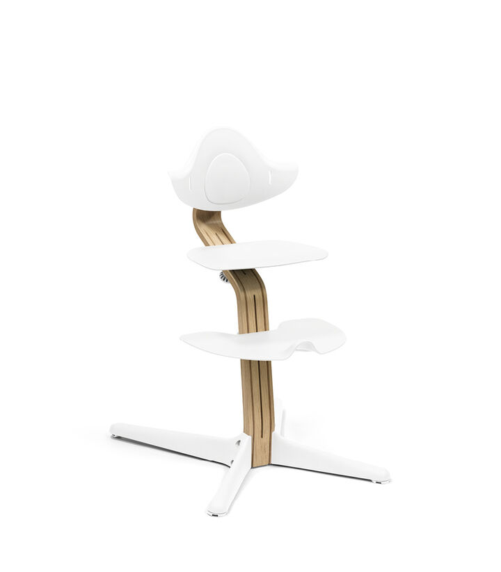 Stokke® Nomi® Chair. Premium Oak wood and White plastic parts.  view 1