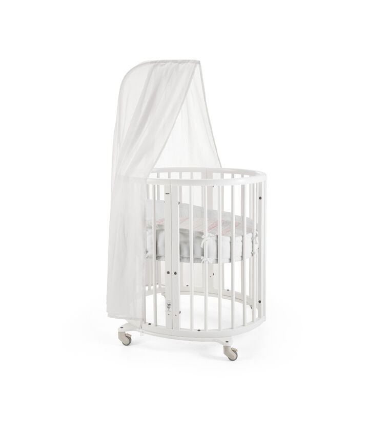 Stokke® Sleepi Mini, Natural. Canopy, Bumper and Fitted Sheet, Coral Straw. view 1