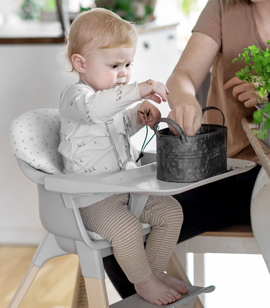 Stokke® Clikk™ High Chair. Natural Beech with  Cloud Grey plastic parts and Blueberry Boat cushion.