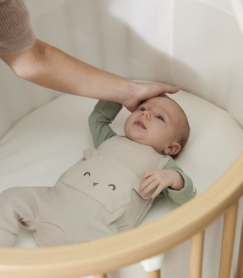 Stokke® Sleepi™ Mini V3 Natural with Mattress. Emotional close-up. Top view. galery image 2