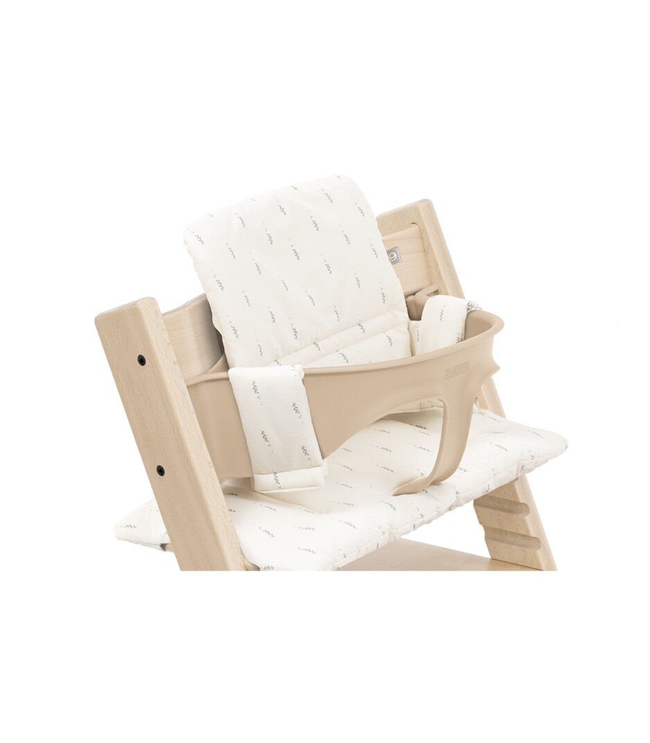 Tripp Trapp® chair Natural with Baby Set and Classic Cushion Wheat Cream. Close-up.
