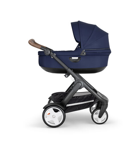 Stokke® Trailz™ with Black Chassis, Brown Leatherette and Classic Wheels. Stokke® Stroller Carry Cot, Deep Blue. view 2