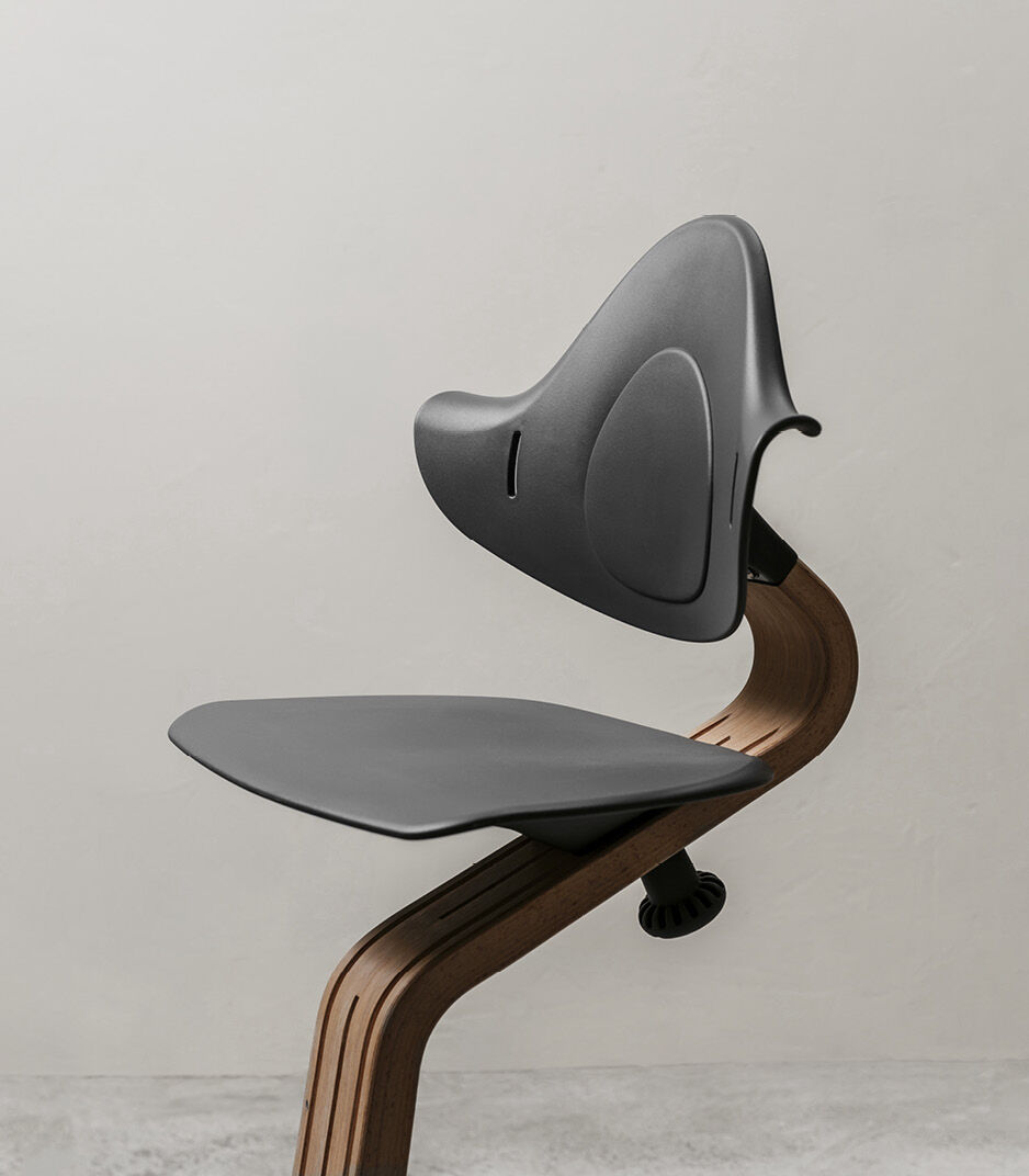 Stokke® Nomi® Chair. Walnut premium wood and Anthracite plastic parts. Styled/detail. galery image 5