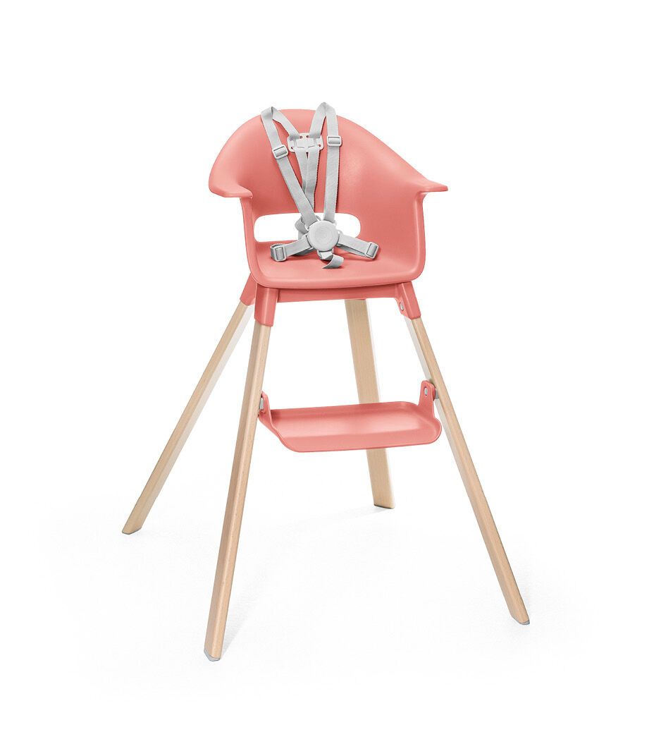 Stokke® Clikk™ High Chair. Natural Beech wood and Sunny Coral plastic parts. Stokke® Harness attached. Footrest high.