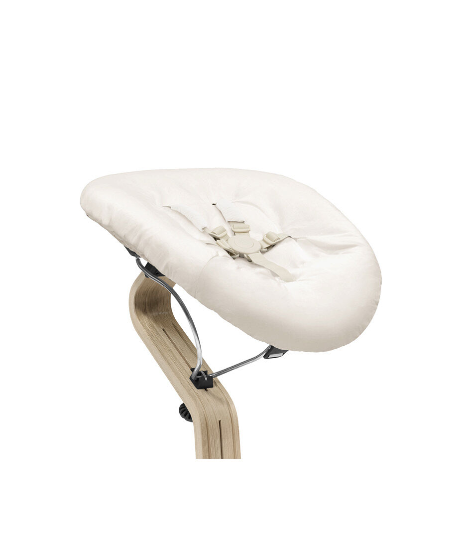 Stokke® Nomi® Chair Natural-Black with Newborn Set Sand. Close-up.