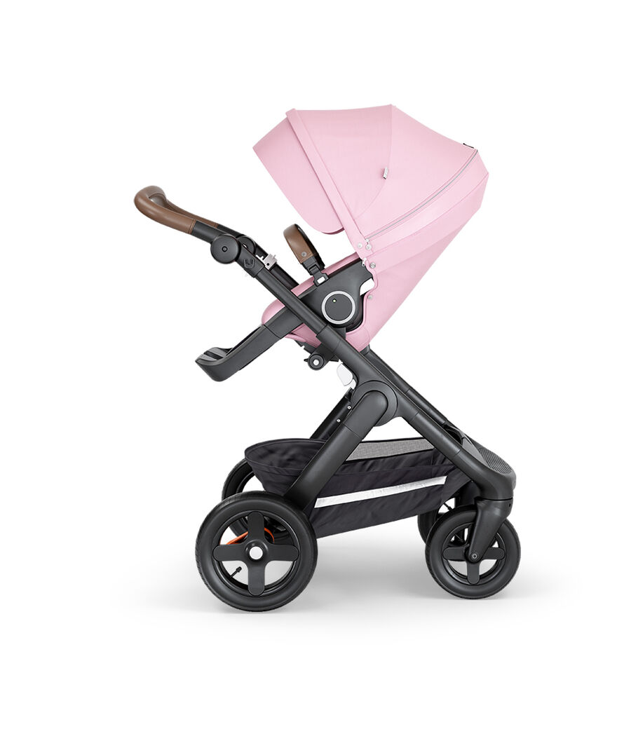 Stokke&reg; Trailz&trade; with Black Chassis, Brown Leatherette and Terrain Wheels. Stokke&reg; Stroller Seat, Lotus Pink.