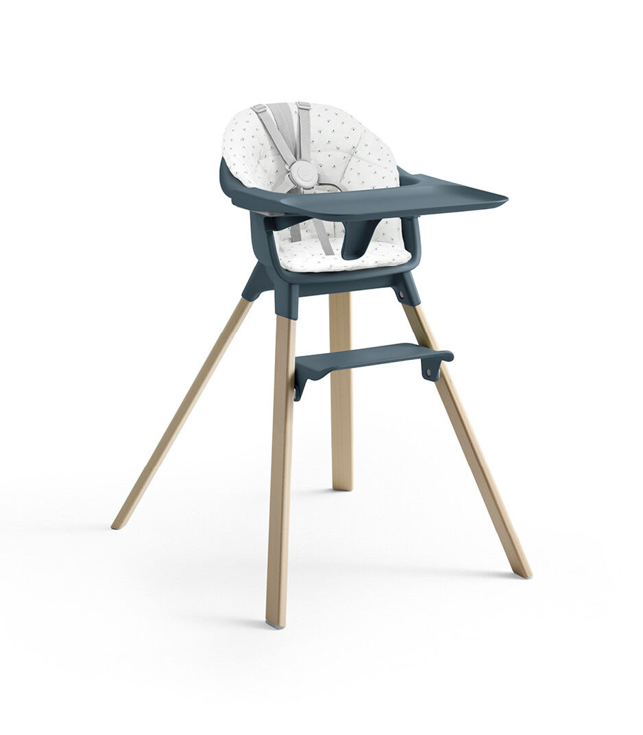 Stokke® Clikk™ High Chair. Natural Beech wood and Fjord Blue plastic colours and Blueberry Boat cushion.