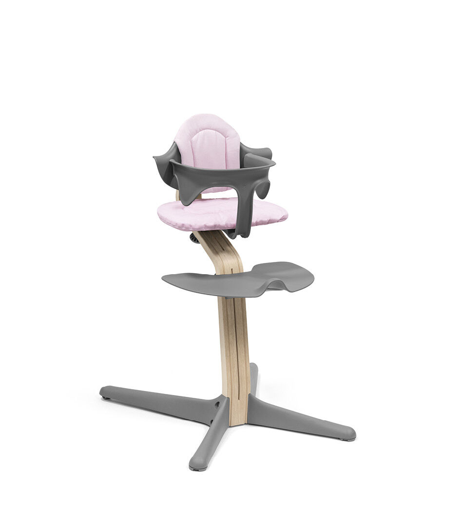 Stokke® Nomi® Chair Natural-Grey with Baby Set and Pink Cushions.
