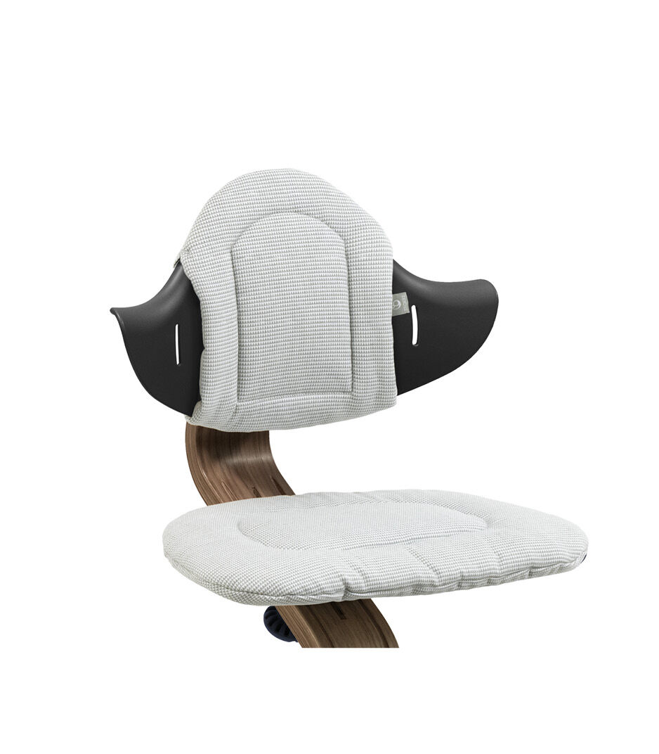 Stokke® Nomi® Chair. Premium Walnut wood and Black plastic parts. Cushion Nordic Grey. Close-up.