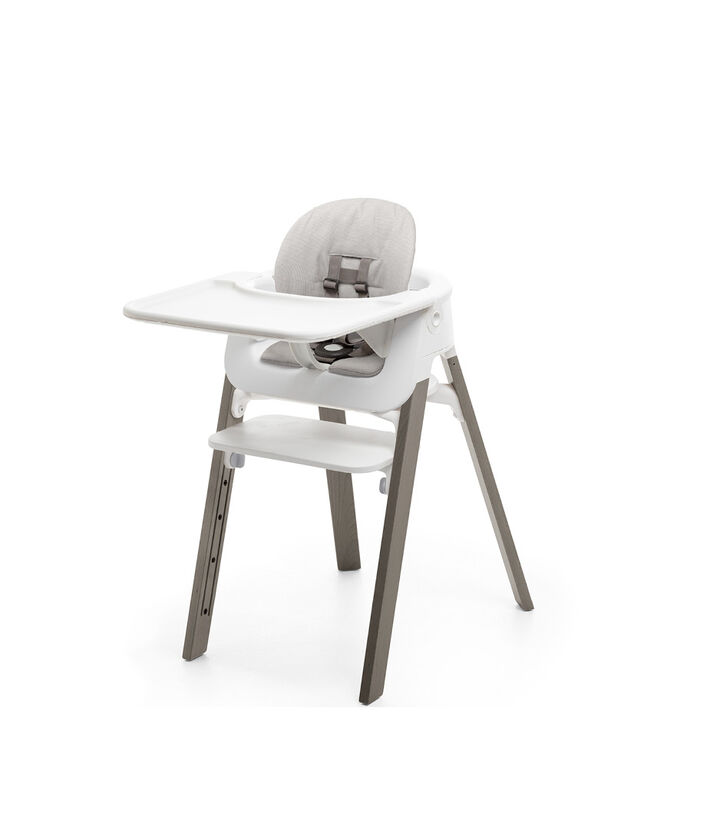 Stokke® Steps™ Hazy Grey with Accessories. Baby Set White. Baby Set Cushion Timeless Grey. Baby Set Tray White. view 1
