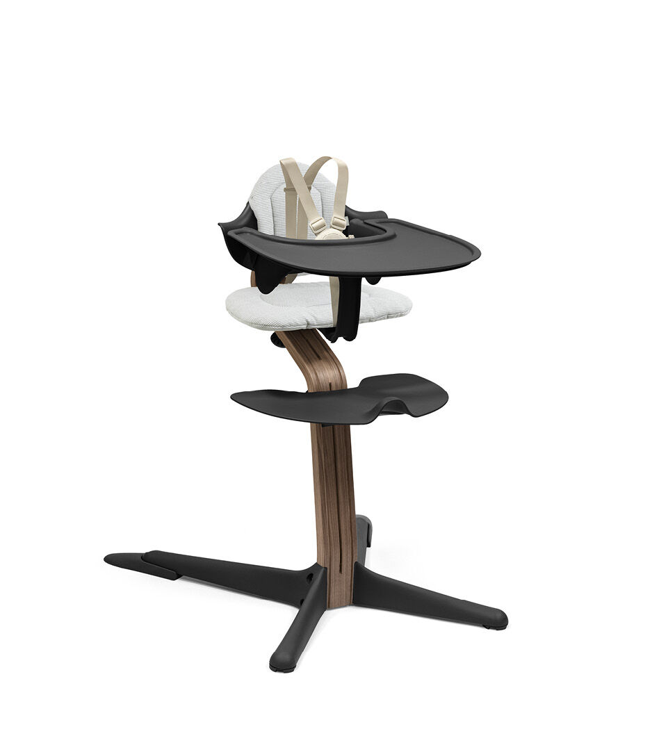 Stokke® Nomi® Chair. Premium Walnut wood and Black plastic parts. With Baby Set and Tray, Black. Cushion Nordic Grey. US variant with harness and leg extensions. galery image 12