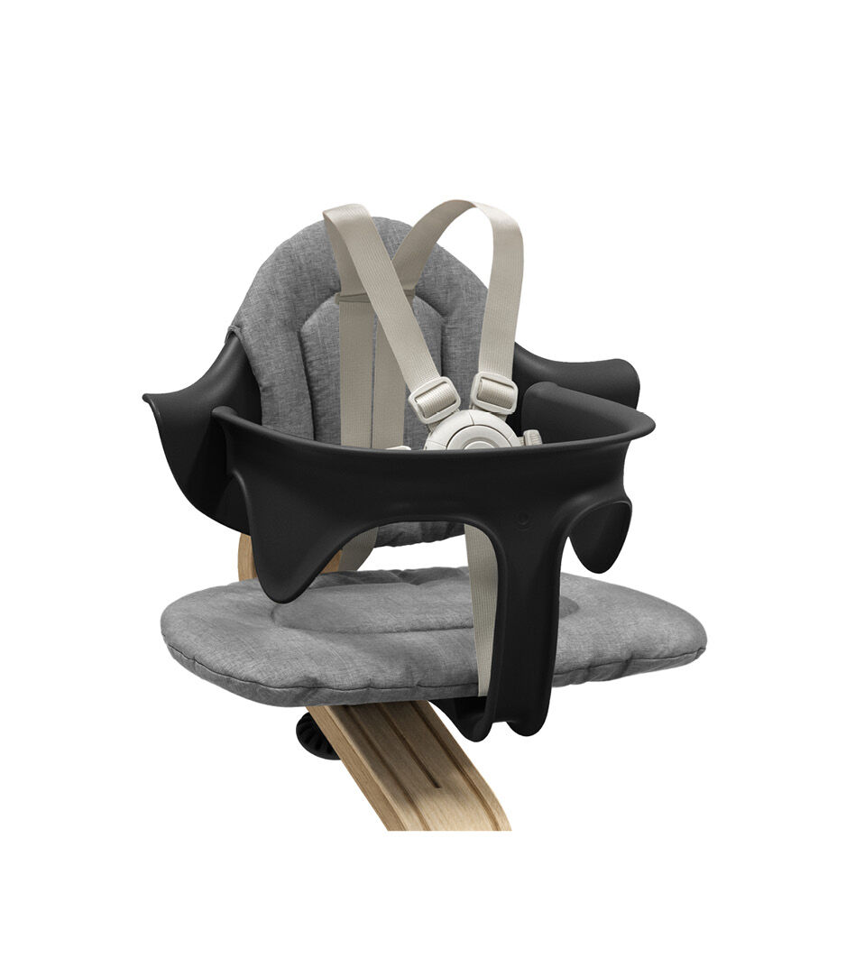Stokke® Nomi® Chair. Premium Oak wood and Black plastic parts. With Baby Set Black. Close-up. galery image 3