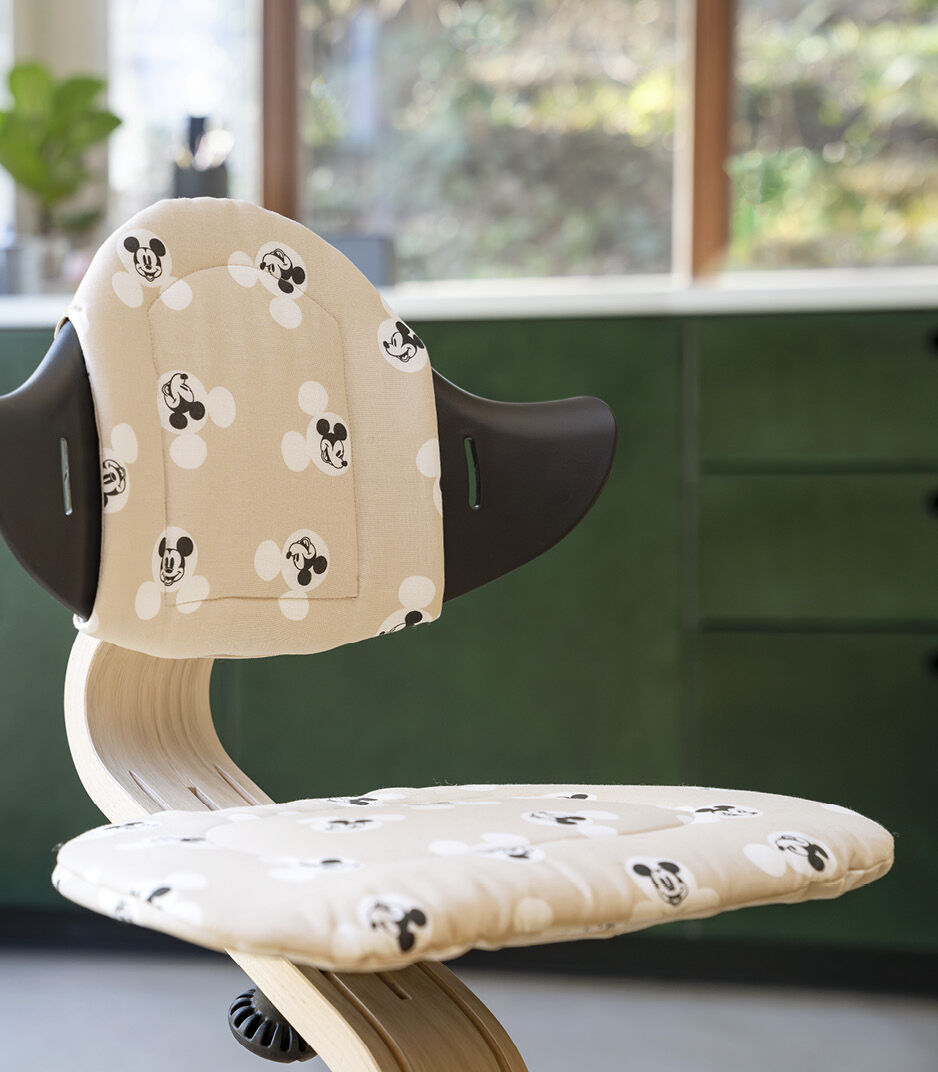 Stokke® Nomi® Chair Natural/Black with Disney Mickey Signature cushion. Close-up.