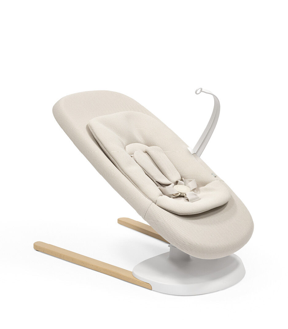 Stokke® Yoga™ Bouncer Light Sand. Low position with inlay. Toy Hanger. galery image 1