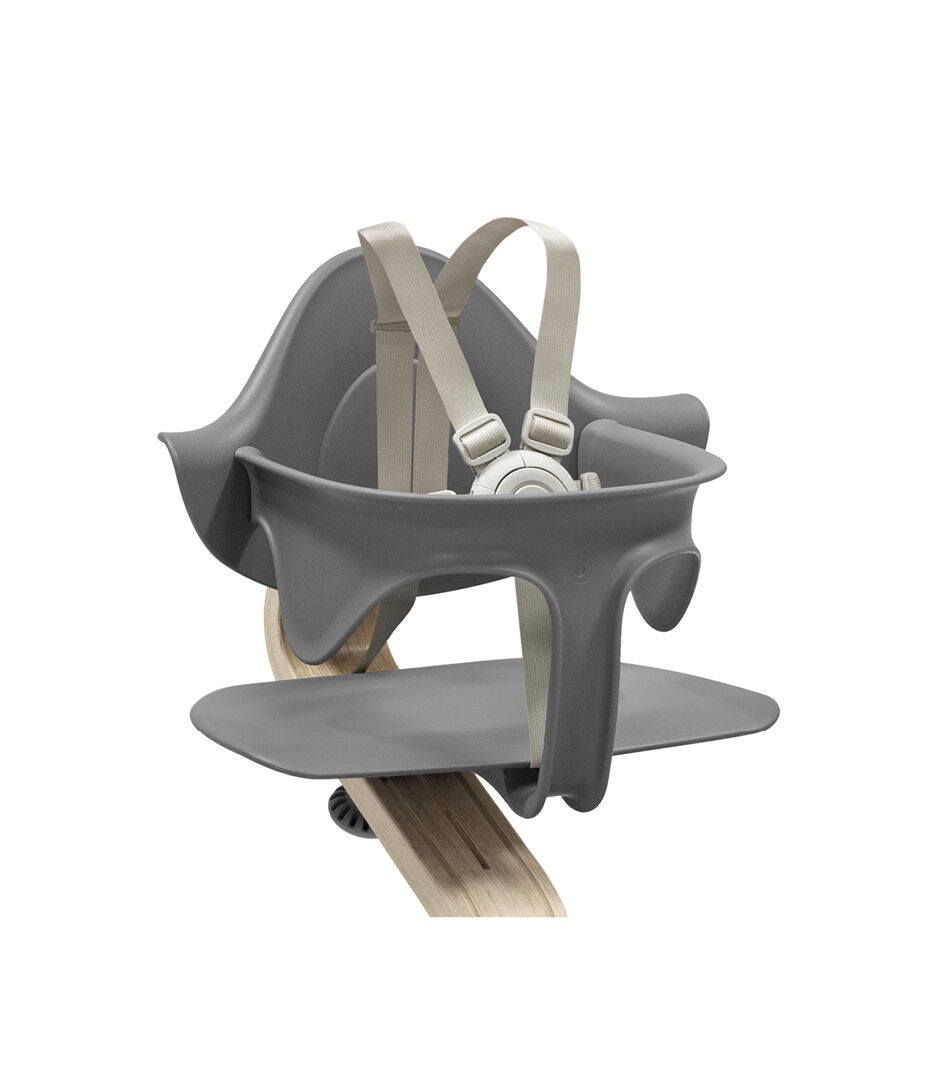 Stokke® Nomi® Chair Natural-Grey with Baby Set. US variant w/Harness. Close-up.