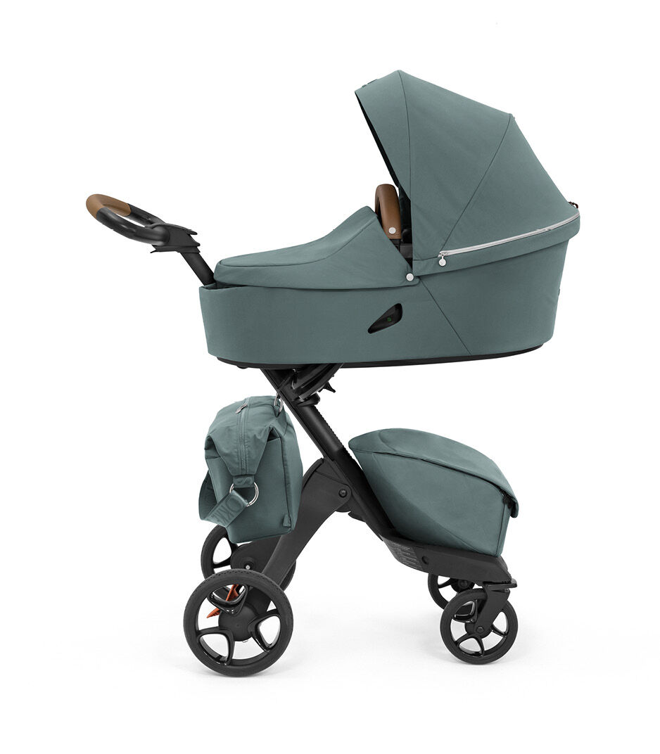 Stokke® Xplory® X Changing Bag Cool Teal on the stroller. Carry Cot.