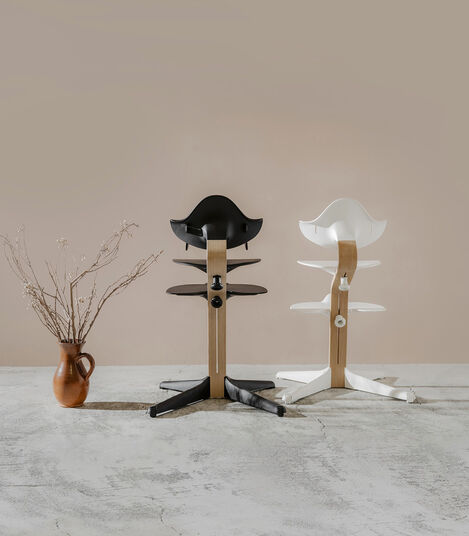 Stokke® Nomi® Chair. Oak premium wood, Black and White plastic parts. Styled. view 7