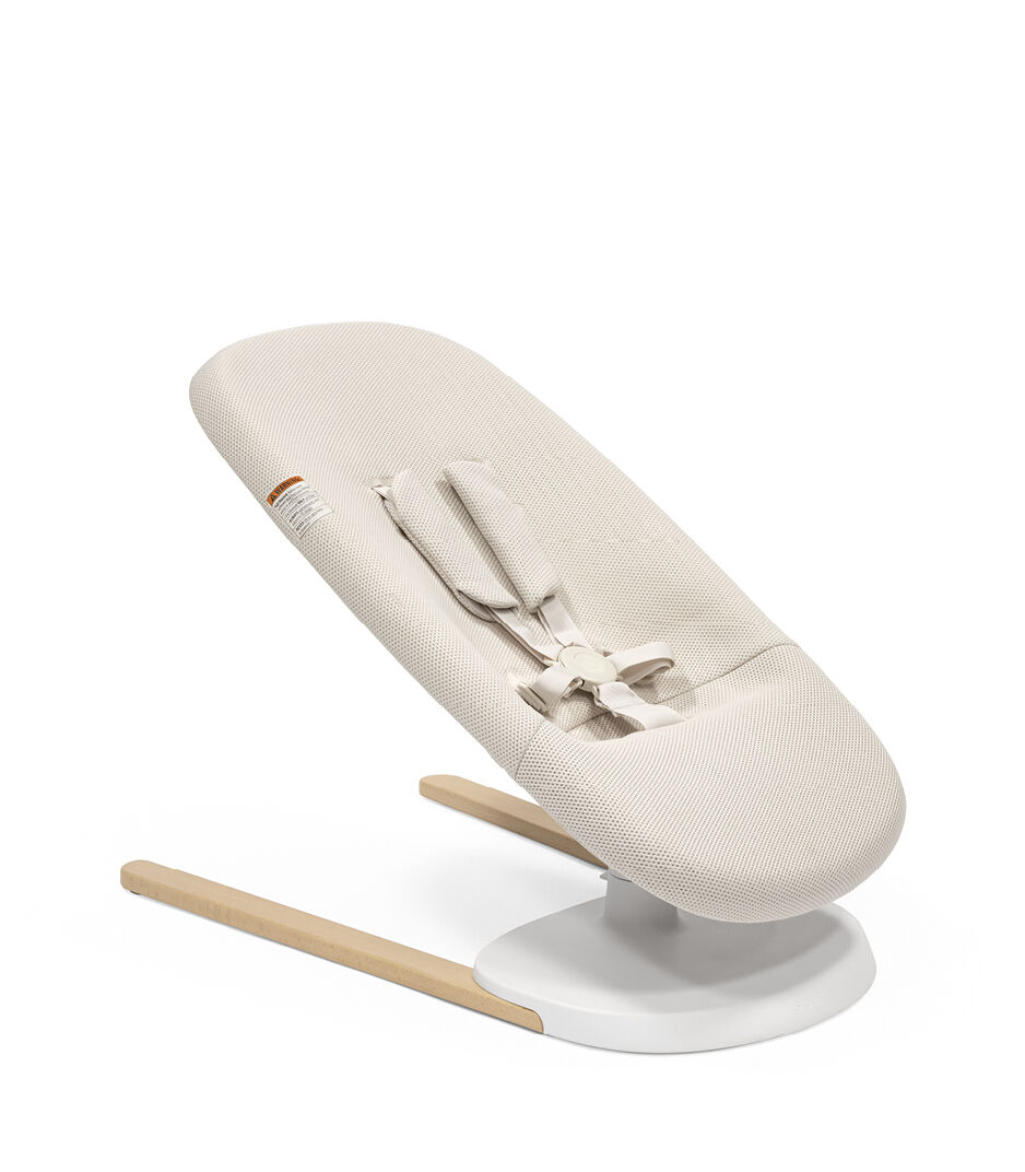Stokke® Yoga™ Bouncer Light Sand. Low position without inlay. Angled view. US variant. galery image 13