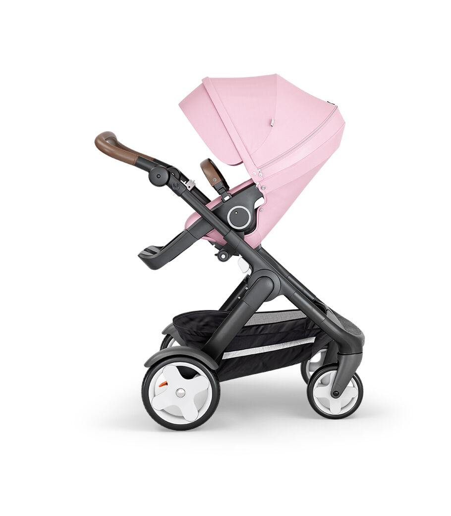 Stokke&reg; Trailz&trade; with Black Chassis, Black Leatherette and Classic Wheels. Stokke&reg; Stroller Seat, Lotus Pink.