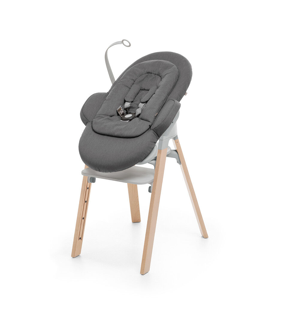 Stokke® Steps™ Natural and Light Grey plastic with Stokke® Steps Bouncer in Deep Grey..