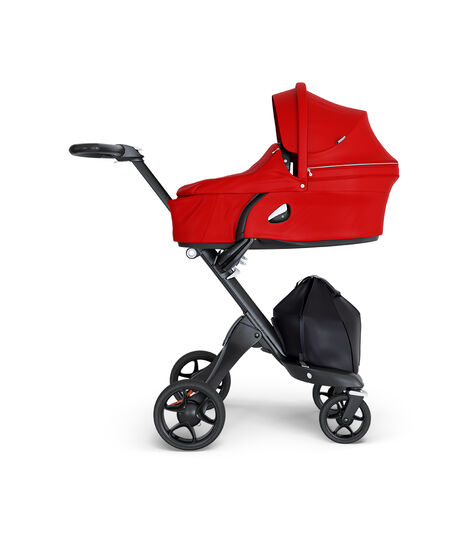 Stokke® Xplory® wtih Black Chassis and Leatherette Black handle. Stokke® Stroller Carry Cot Red. view 4