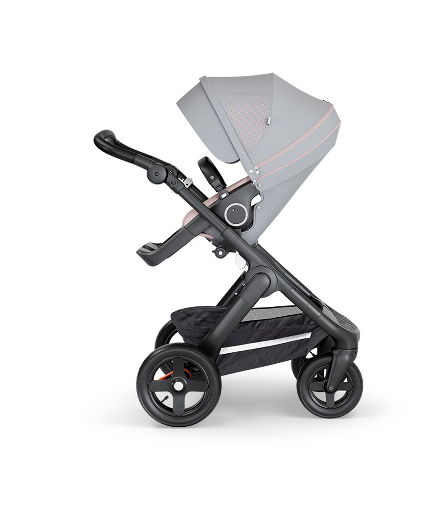 Stokke&reg; Trailz&trade; with Black Chassis, Black Leatherette and Terrain Wheels. Stokke&reg; Stroller Seat, Athleisure Pink.