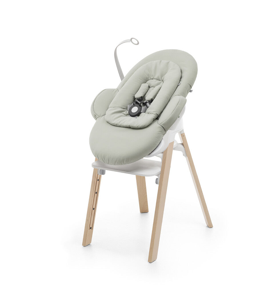 Stokke® Steps™ Natural, White plastic with Stokke® Steps Bouncer Soft Sage.