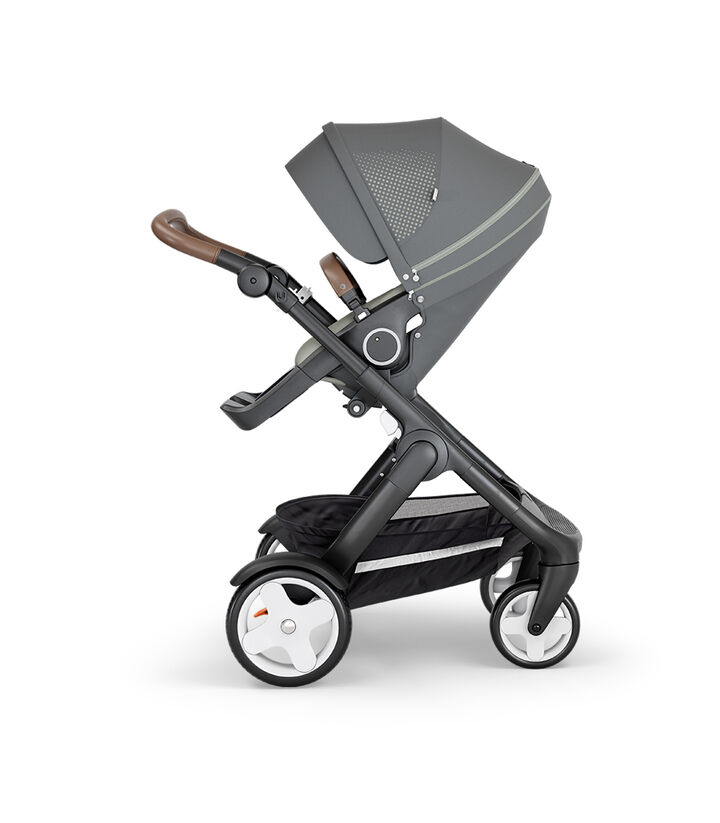 Stokke® Trailz™ with Black Chassis, Brown Leatherette and Classic Wheels. Stokke® Stroller Seat, Athleisure Green.