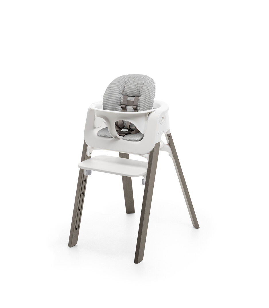 Stokke® Steps™ Storm Grey with Baby Set and Nordic Grey Cushion.