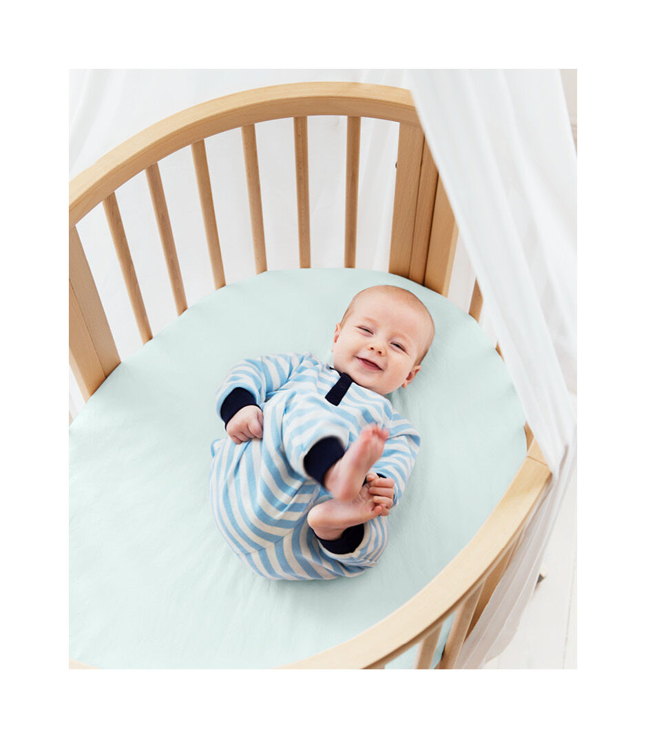 Stokke® Sleepi™ Mini Bed, Natural with Fitted Sheet Powder Blue.