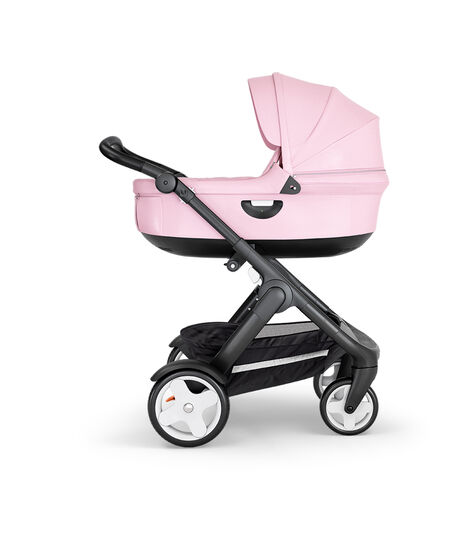 Stokke® Trailz™ with Black Chassis, Black Leatherette and Classic Wheels. Stokke® Stroller Carry Cot, Lotus Pink. view 2