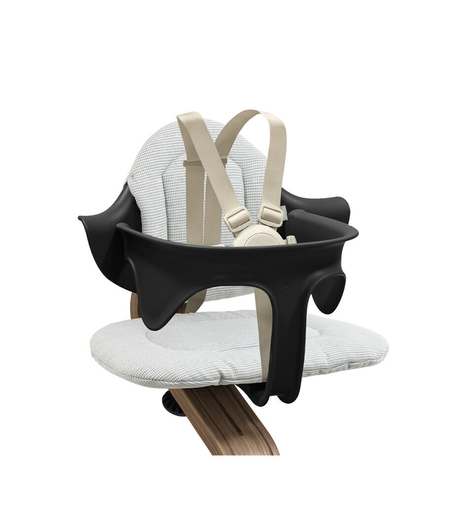 Stokke® Nomi® Chair. Premium Walnut wood and Black plastic parts. With Baby Set, Black. Cushion Nordic Grey. US variant with harness and leg extensions. Close-up. galery image 8