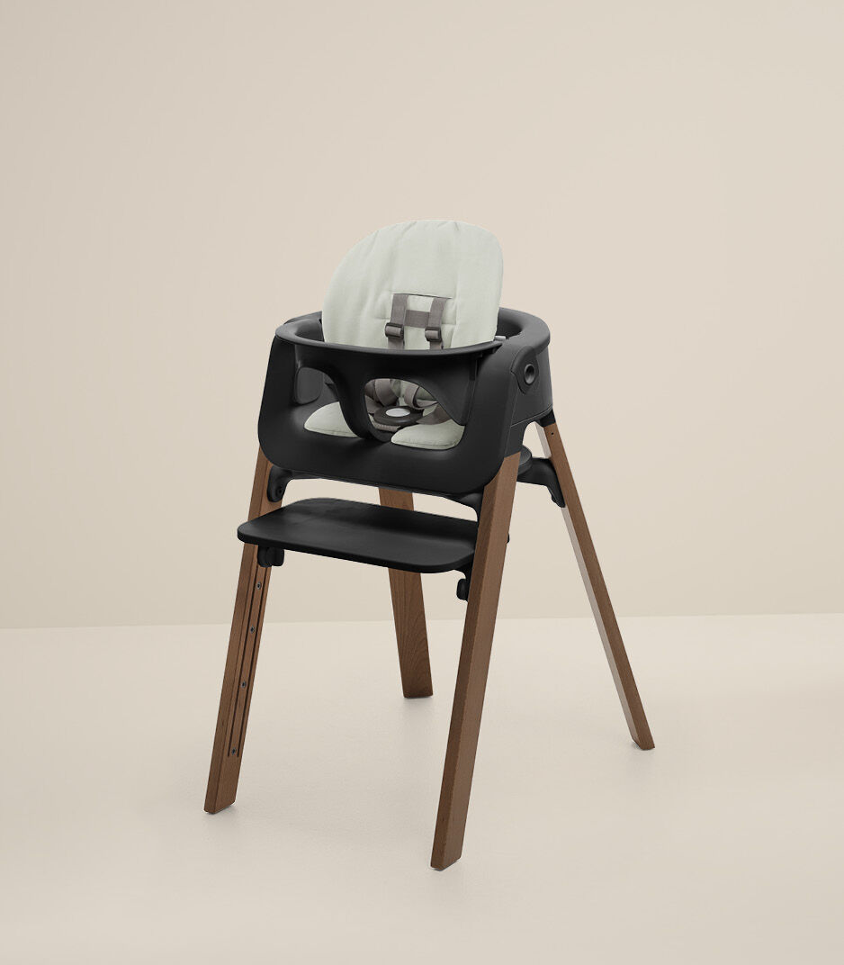 Stokke® Steps™ Chair Golden Brown with Baby Set Black and Cushion Soft Sage.