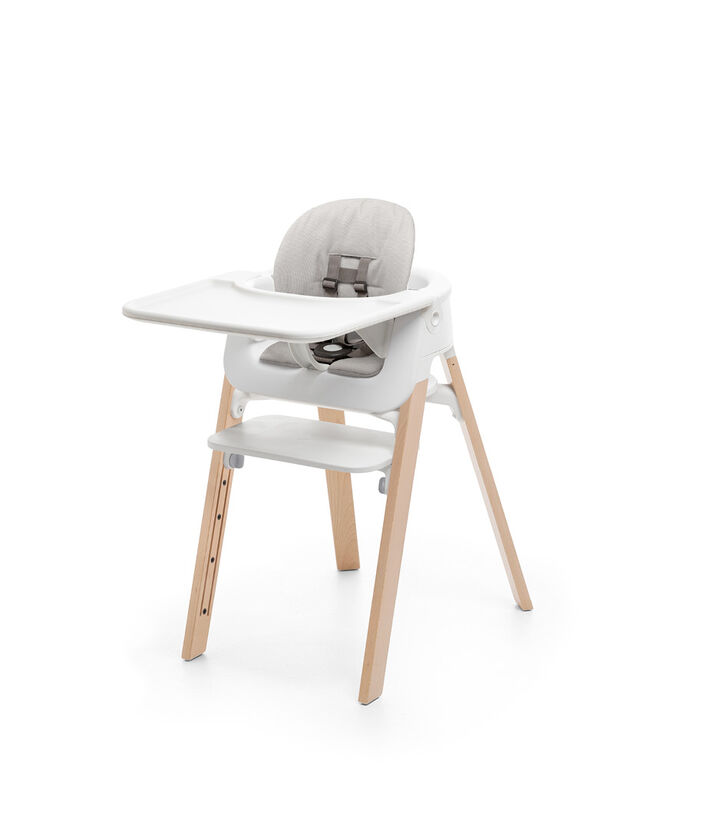 Stokke® Steps™ Chair Natural. Baby Set White. Cushion Timeless Grey. Baby Set Tray White. view 1