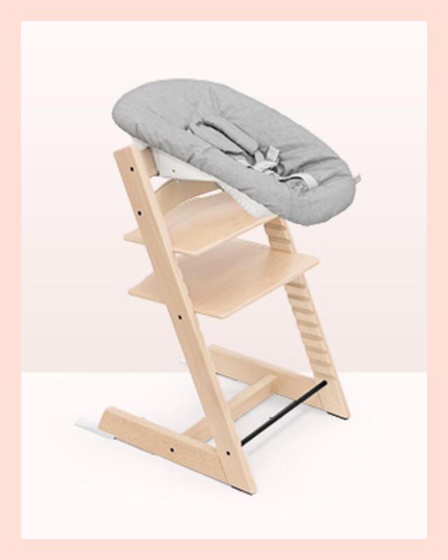 A tripp trapp chair in color natural with a grey newborn set.