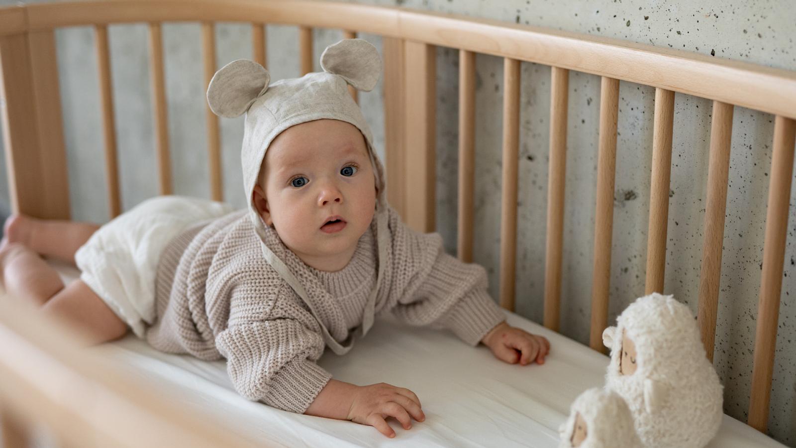 Baby in Sleepi bed crib.
