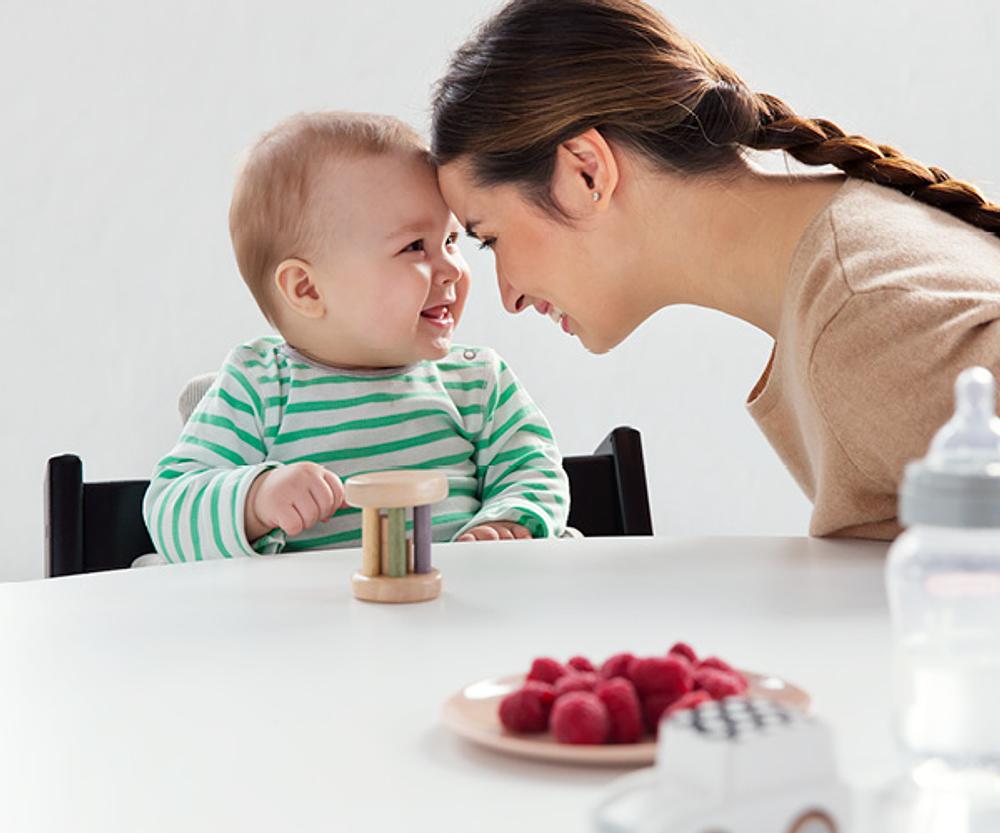 Mom and baby sticking heads together and smiling