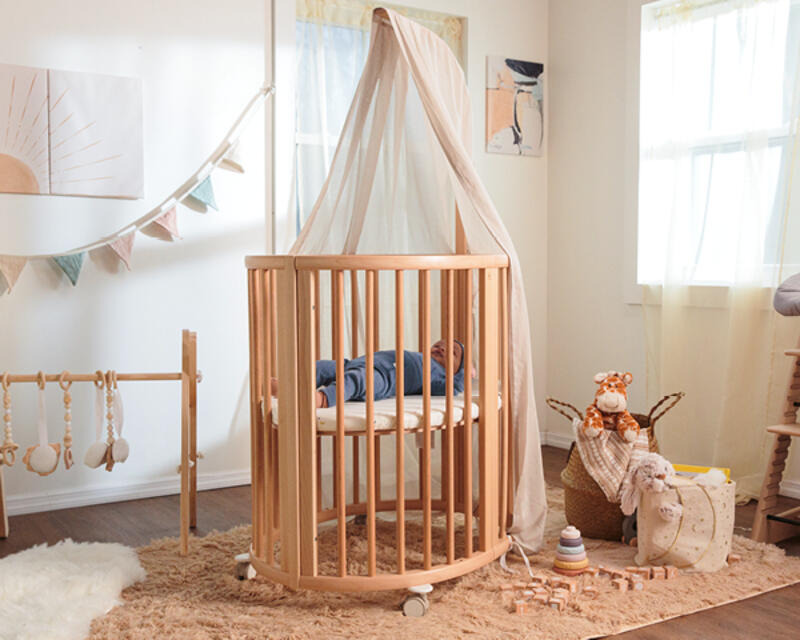 Baby in their nursery resting in the Stokke® Sleepi™ Mini.