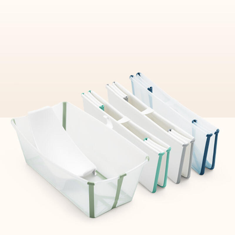 Three folded flexi baths in multiple colors lined up next to an open flexi bath with newborn insert inside.
