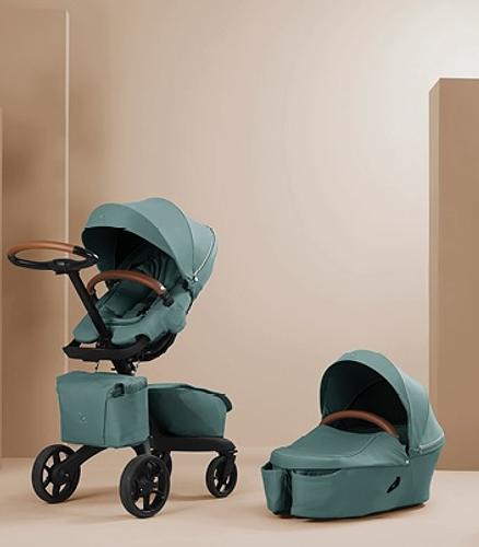 Stokke Xplory X stroller with carry cot in color Cool Teal.