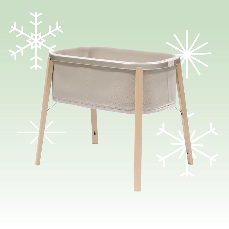 Snoozi bassinet with holiday background.