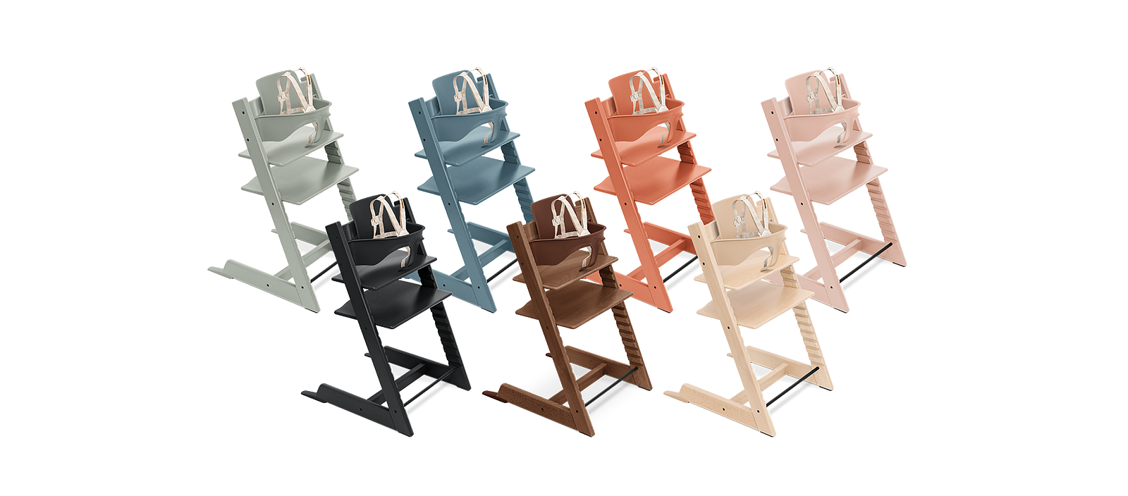 Eight colorful Tripp Trapp high chairs with Baby Sets, arranged on a white background.