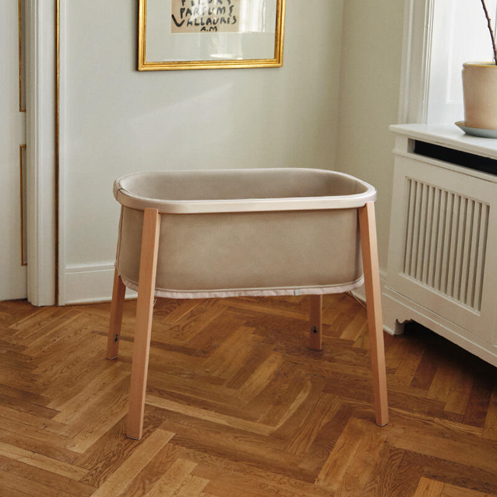 Snoozi bassinet standing in baby nursery.