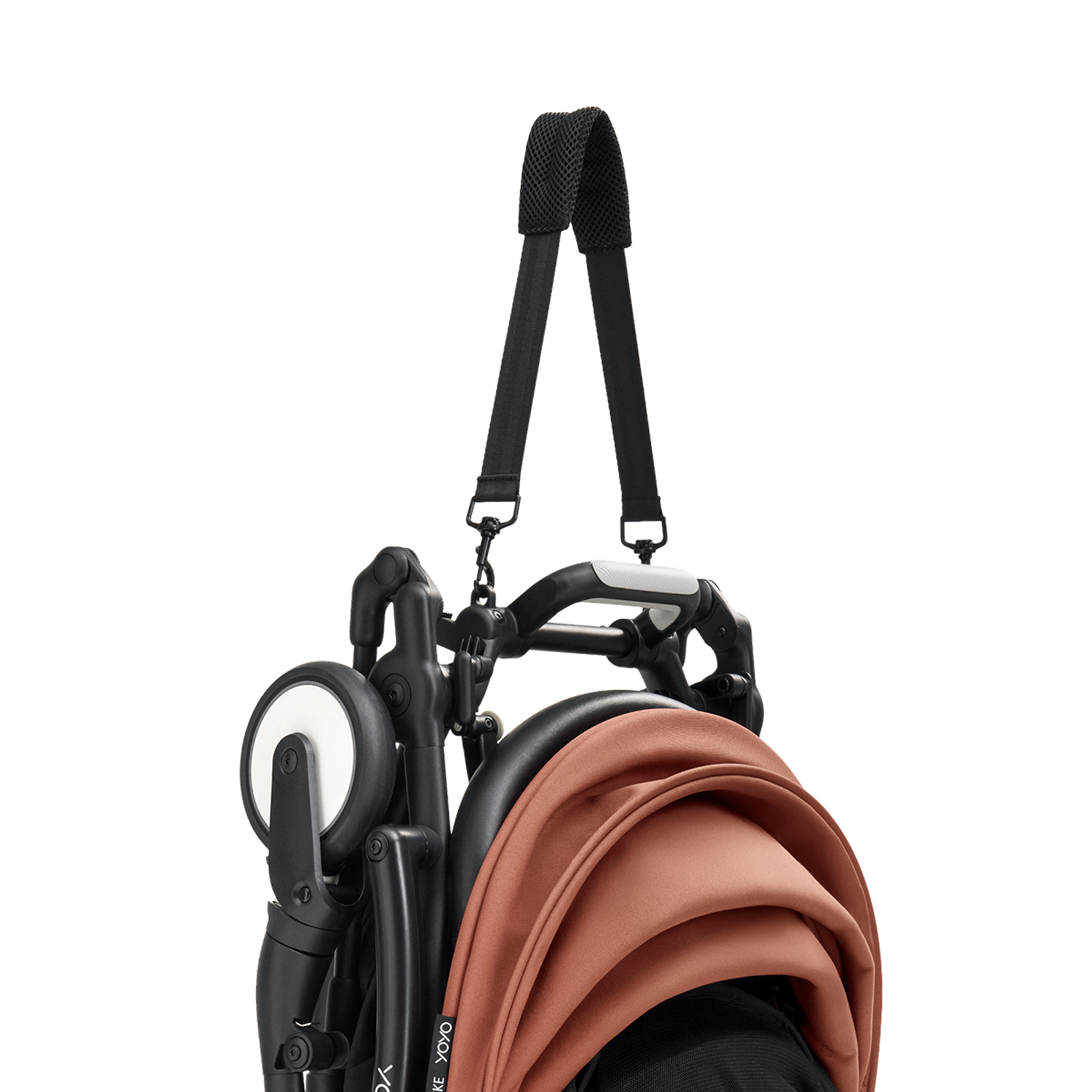 Folded STOKKE YOYO stroller with a burnt orange canopy and black shoulder strap.