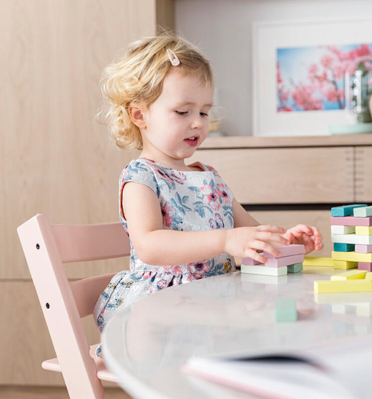 Baby girl playing with bricks