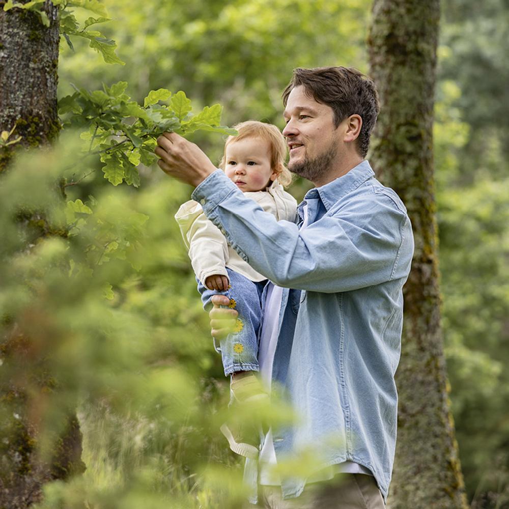 Father with baby in forest