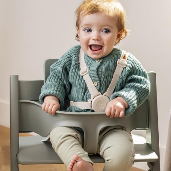 Baby in a tripp trapp high chair glacier green.