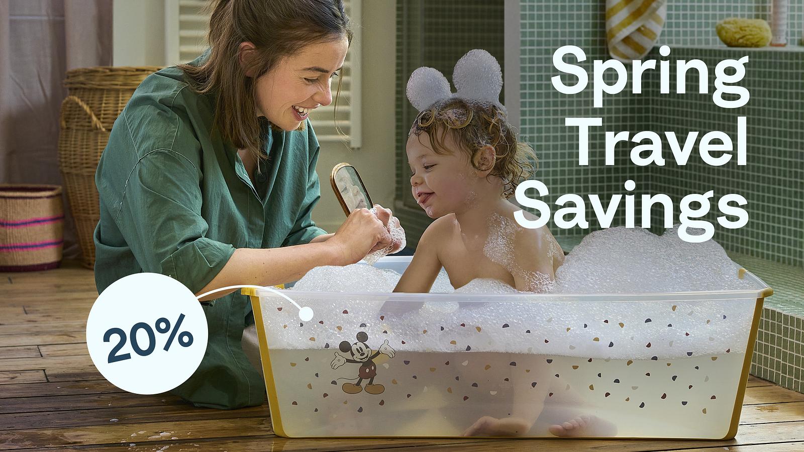 Mother bathing child in flexibath. Spring travel savings.